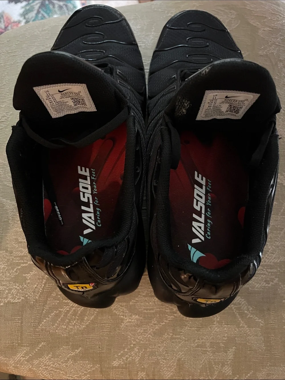 Nike Air Max Plus (Men’s) Triple Black Sneakers with Subtle Red Interior Accents